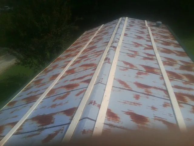 Rusted metal roof panels with new wood purlins before replacement — Storm Damage Roof Repair in Venice by Roofing Brothers